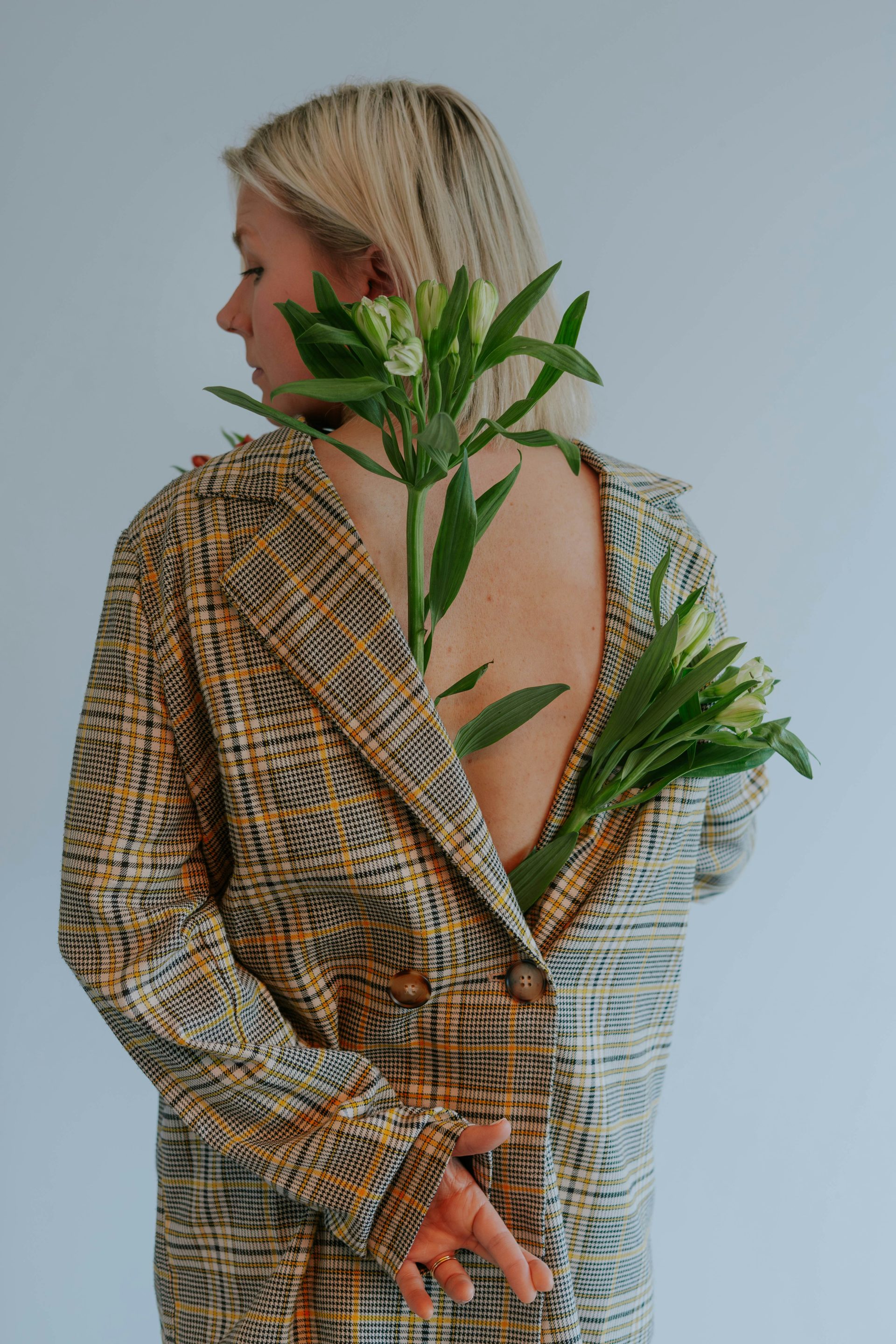 a woman wearing a jacket with flowers in her hair